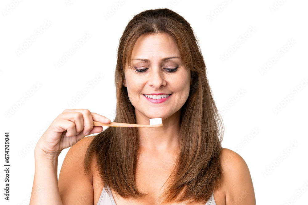 Middle age woman over isolated background with a toothbrush Middle age woman over isolated background with a toothbrush
