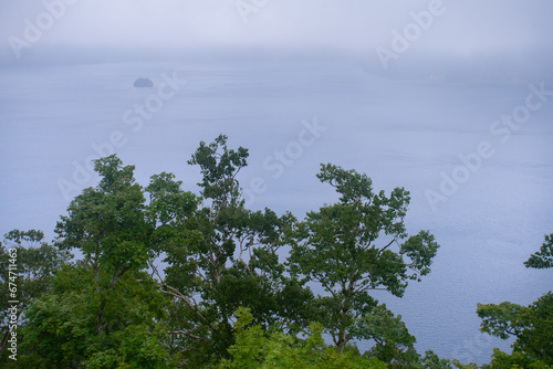 Lake Mashu, an endorheic crater lake formed in the caldera of a potentially active volcano in Akan Mashu National Park, Teshikaga, Kushiro Subprefecture, Hokkaido, Japan photo