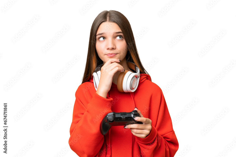 Teenager caucasian girl playing with a video game controller over isolated background and looking up Teenager caucasian girl playing with a video game controller over isolated background and looking up