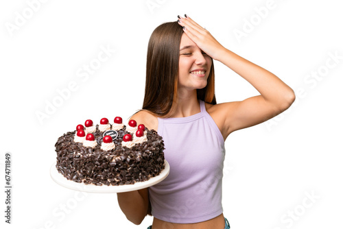 Teenager caucasian girl holding birthday cake over isolated background has realized something and intending the solution