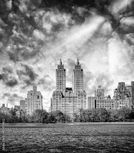 New York City at sunset. Panoramic view of Manhattan buildings from Central Park Lake