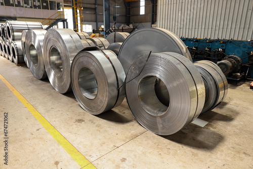 A wide view of industrial machines manufacturing metal sheets in a warehouse photo