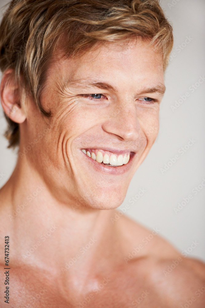 Obraz premium Man, topless and smile in studio or white background for positive energy, healthy or confidence. Male person, model or shirtless relax masculine for strong shoulders or attractive, calm or muscle