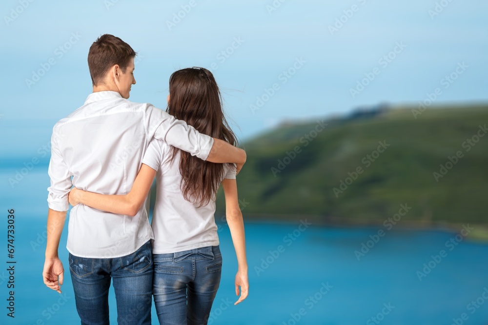 Happy couple walking on beach sand Happy couple walking on beach sand