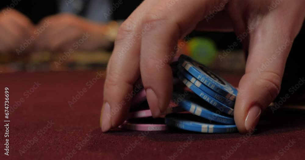 Hands of a young woman playing cards on a red velvet background Hands of a young woman playing cards on a red velvet background