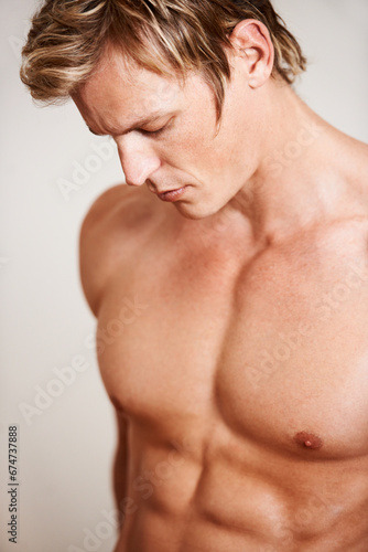 Man, shirtless and muscle on studio background or thinking confidence, bodybuilder or chest. Male person, model or topless abs for masculine strength or flexing pose or attractive, strong in Norway