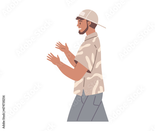 Young guy standing and talking isolated on white background. Man is looking at something behind him. Male alone character. Person stands side view, makes gesture with hands and emotionally speaks