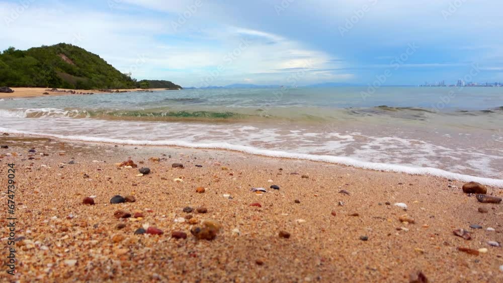 Landscape of rocky beach and sea with distant mountains and islands, blue sky. Landscape of rocky beach and sea with distant mountains and islands, blue sky.