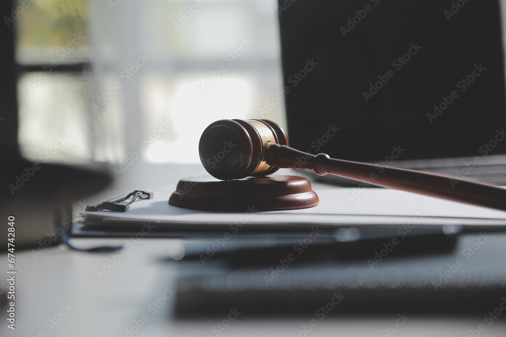 Business and lawyers discussing contract papers with brass scale on desk in office. Law, legal services, advice, justice and law concept picture with film grain effect - obrazy, fototapety, plakaty 