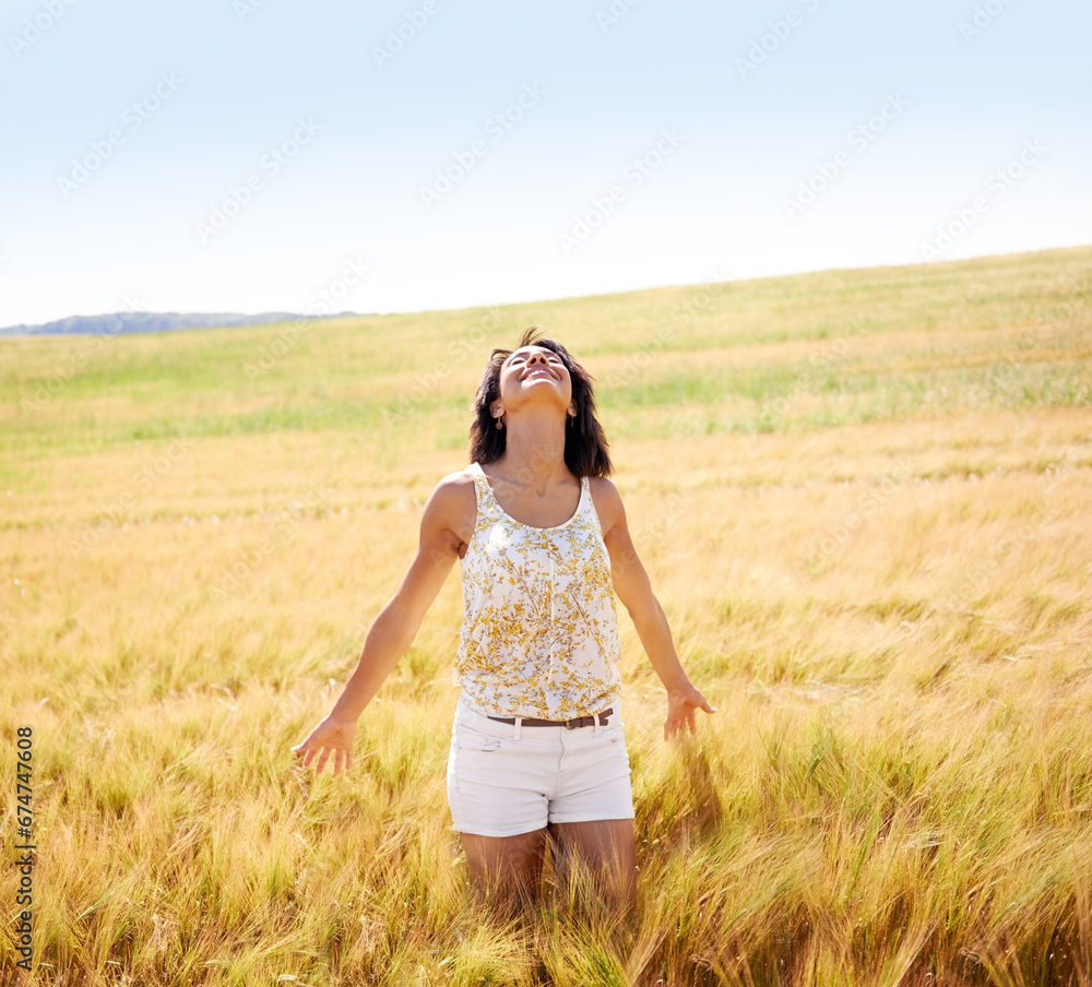 Breathing, freedom or happy woman in a field in the countryside in spring to relax on break. Smile, wellness or female person in farm for fresh air on holiday vacation, gratitude or travel in nature