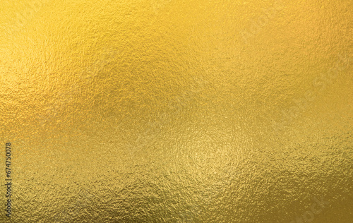 Gold wall texture background. Yellow shiny gold foil paint on wall sheet with gloss light reflection, vibrant golden paper luxury wallpaper © merrymuuu
