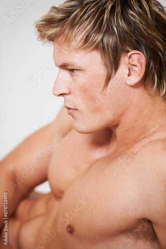 Man  topless and muscle in studio or white background for confident masculine  strong body or bodybuilder pride. Male person  model and shirtless for bicep arms or shoulders  attractive in Norway