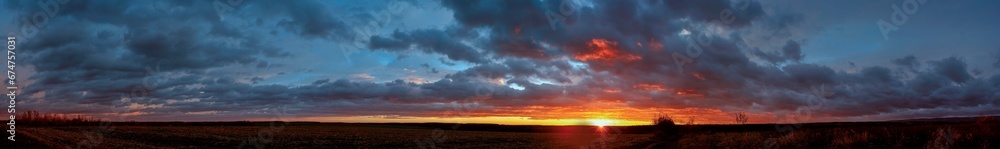 Summer sunset over wheat field. Beautiful sunset sky over countryside