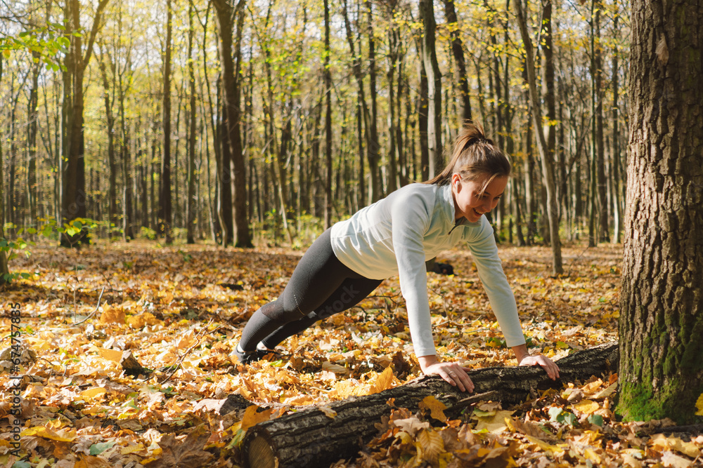 Beautiful girl doing fitness in nature on a sunny autumn forest. Body positive, sports for women, harmony, healthy lifestyle, self-love and wellness. Beautiful girl doing fitness in nature on a sunny autumn forest. Body positive, sports for women, harmony, healthy lifestyle, self-love and wellness.