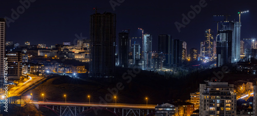 Beautiful panoramic cityscape of Cankaya, Oran and Dikmen districts in Ankara at night. Long exposure photography of Dikmen Valley Bridge and surrounding buildings. photo