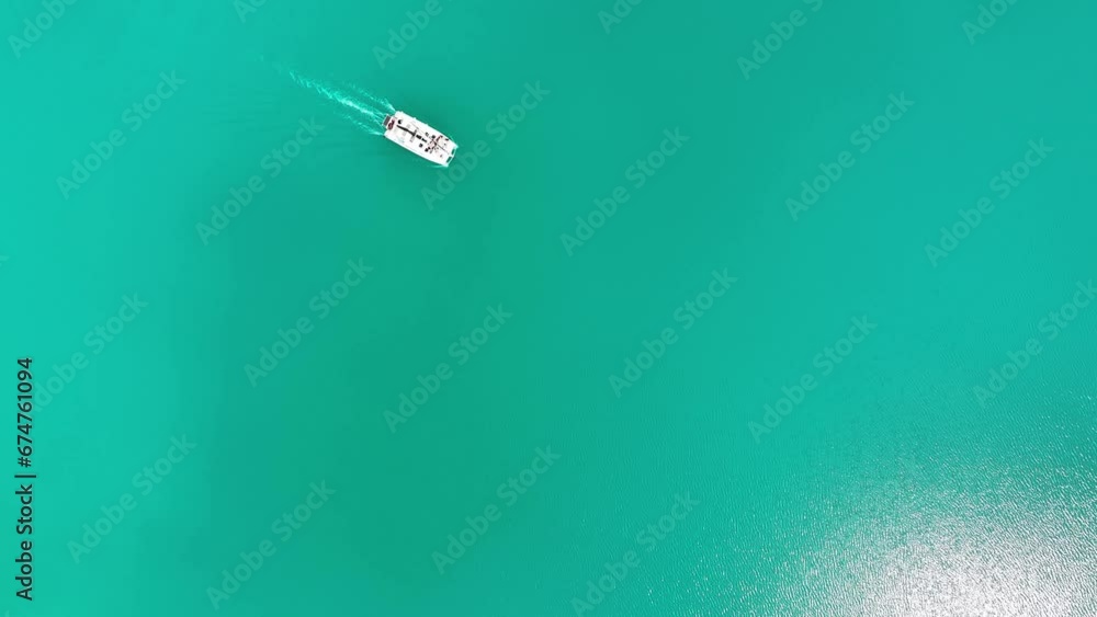 Aerial view of a boat sailing across the Bacalar Lagoon, Quintana Roo, Mexico. Aerial view of a boat sailing across the Bacalar Lagoon, Quintana Roo, Mexico.