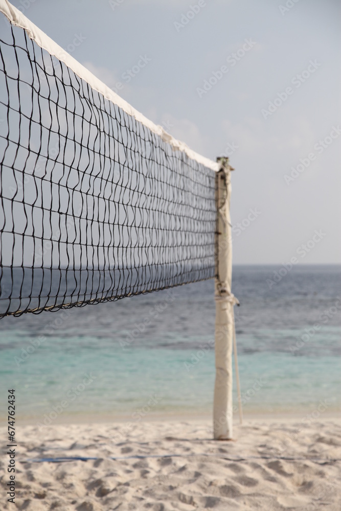 A volleyball net on a white sandy beach on a Maldives island A volleyball net on a white sandy beach on a Maldives island