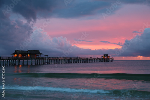 The Naples Beach pier at sunset and during a rough thunderstorm