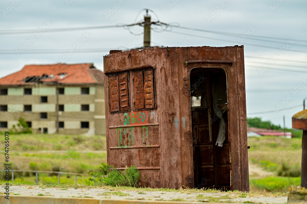 Old rusty container with a window as a car or truck container lies on a green meadow in the Danube Delta in Caraorman, Romania Old rusty container with a window as a car or truck container lies on a green meadow in the Danube Delta in Caraorman, Romania