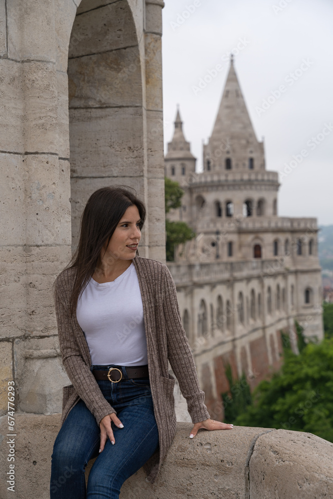 Beautiful young tourist woman posing at the famous Fisherman's Bastion in Budapest