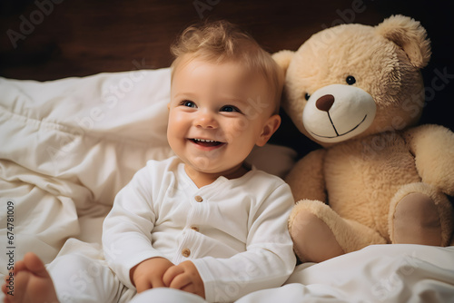 Cute smiling little kid boy with teddy bear toy