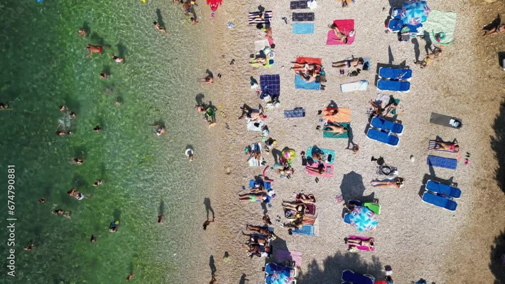 Aerial view of people relaxing at Gortanova beach, a narrow inlet with turquoise water, Pula, Istria, Croatia. Aerial view of people relaxing at Gortanova beach, a narrow inlet with turquoise water, Pula, Istria, Croatia.