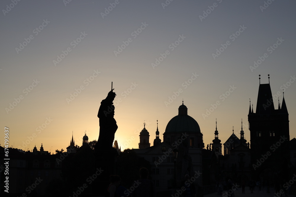 The silhouette of the statues of Charles Bridge in the morning light