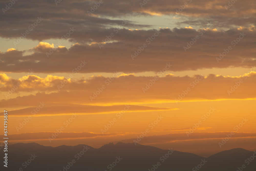 Beautiful bright summer sunset sky with clouds and mountains. Nature sky  background.