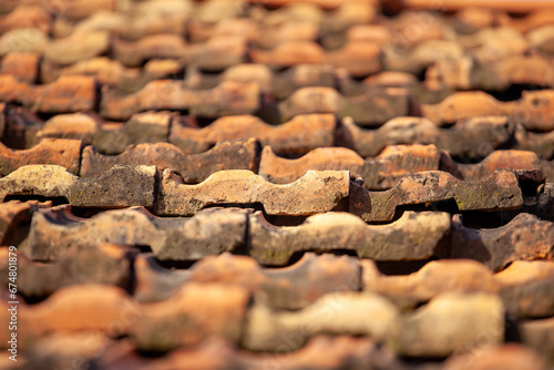 Detail of an old tiled roof on an old house