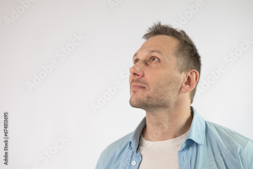 Portrait of an handsome Caucasian man looking up. Isolated on white background.