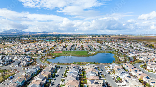 A drone view of a community in Oakley, California with a lake in the center photo