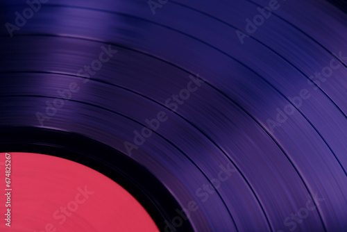 Sound tracks on a vinyl purple record closeup macro photo.