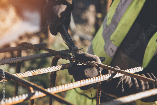 Construction worker steel fixer working at the building  site close-up photo