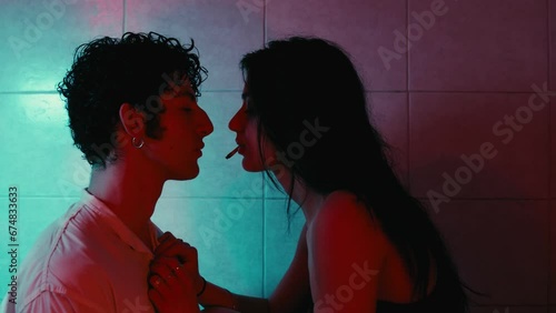 love and drugs - stoned girl undresses her boyfriend  and kisses him erotically
