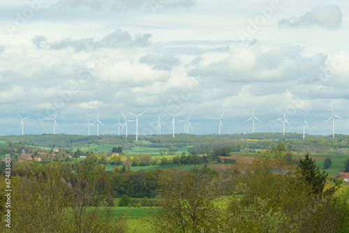 Wind turbines on the background of the field, mountains and clouds