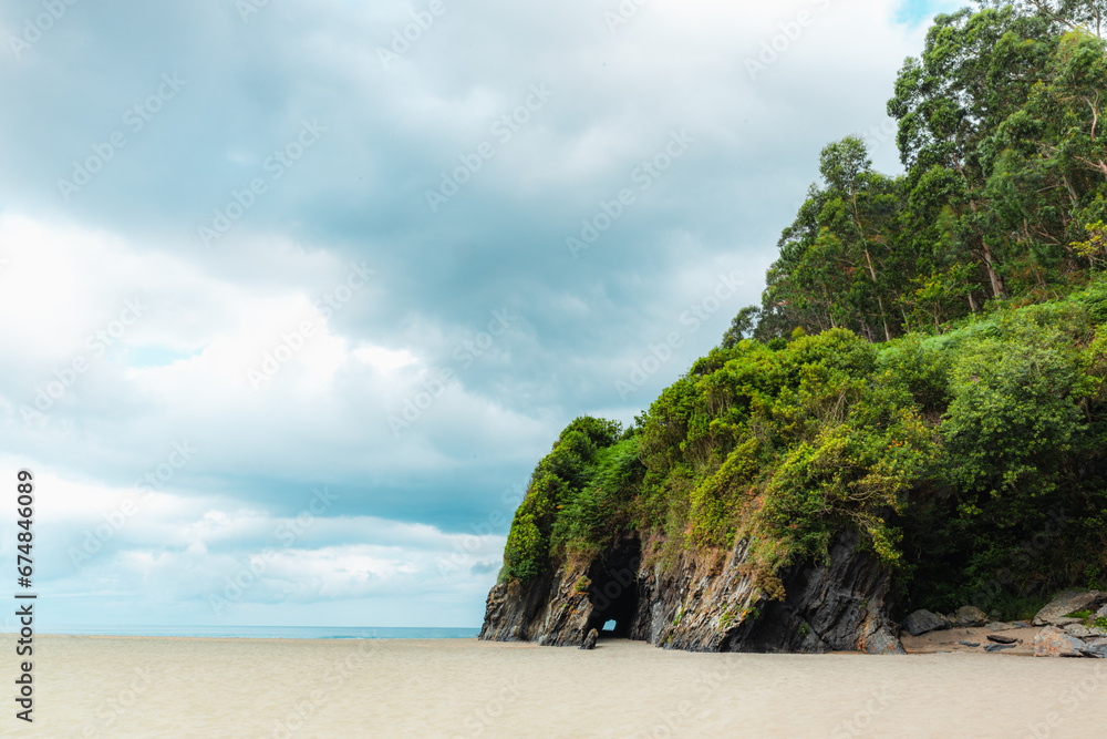 Fototapeta premium Asturias beach with a cliff and forest