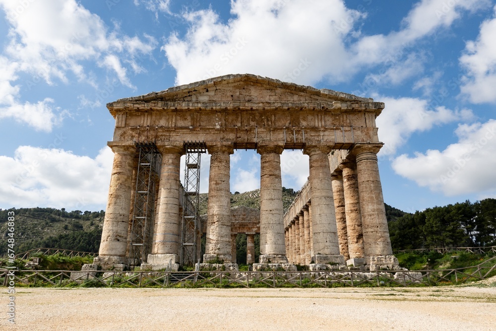 Doric temple of Segesta in sunny spring day with cloudy sky during reconstruction