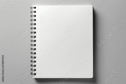 Spiral notebook with blank page on top of it. photo