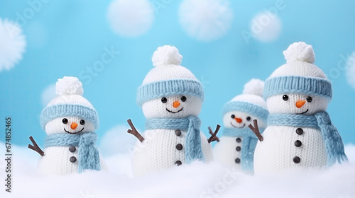 Little knitted snowmans on soft snow © NENUMI