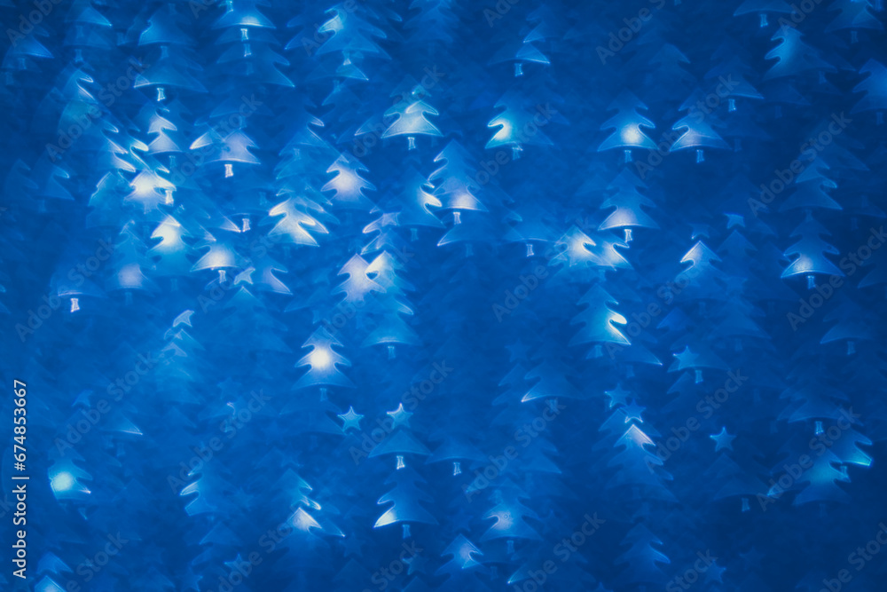 Obraz premium christmas tree shaped structured blue background with bokeh effect