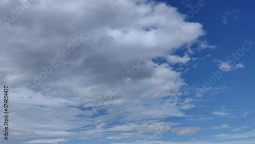 Huge cloud of curious altocumulus clouds cross the sky in symmetry photo