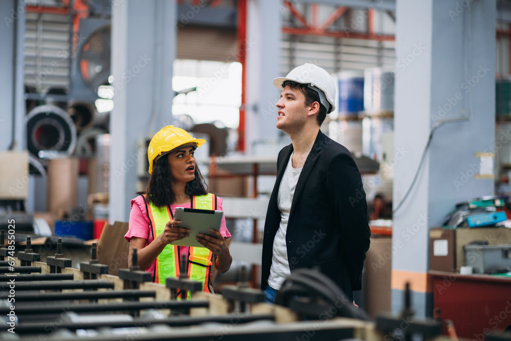 Industrial worker inspecting machine at factory machines. Technician working in the metal sheet company. Foreman checking Material or Machine. Industrial worker inspecting machine at factory machines. Technician working in the metal sheet company. Foreman checking Material or Machine.