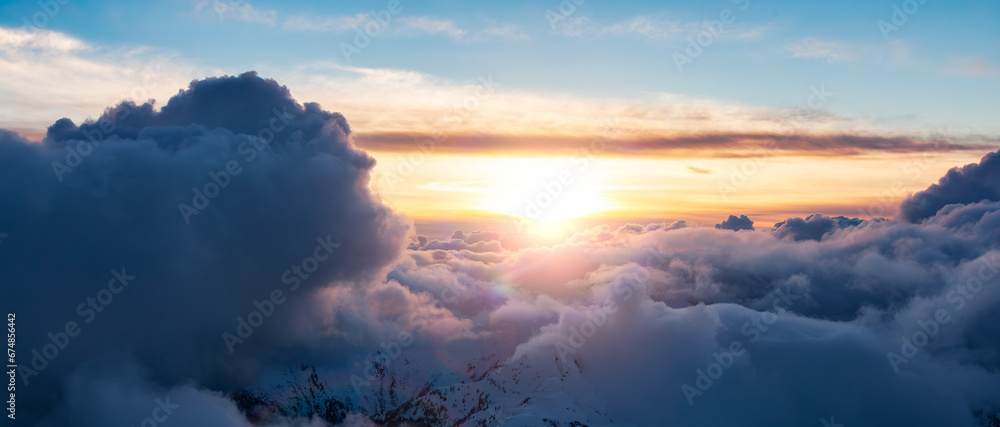 Cloudscape over the Canadian Mountains. Aerial Clouds Background Panorama Sunset