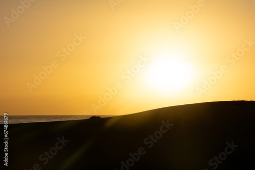 Sunrise over the sand dunes with sea