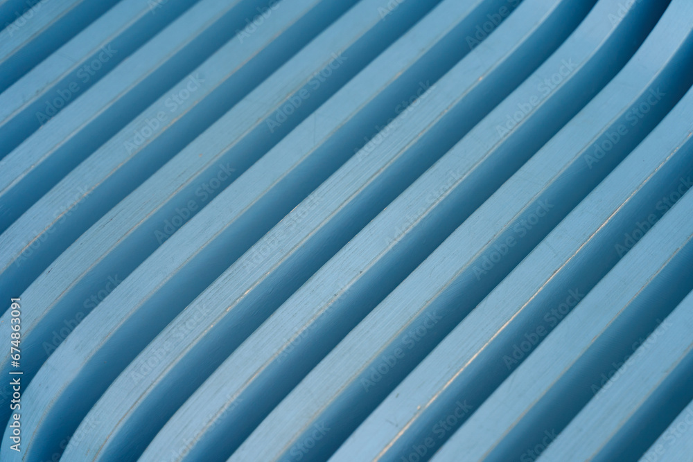 Blue pattern of a wooden bench with curved geometry, vertical slats Blue pattern of a wooden bench with curved geometry, vertical slats