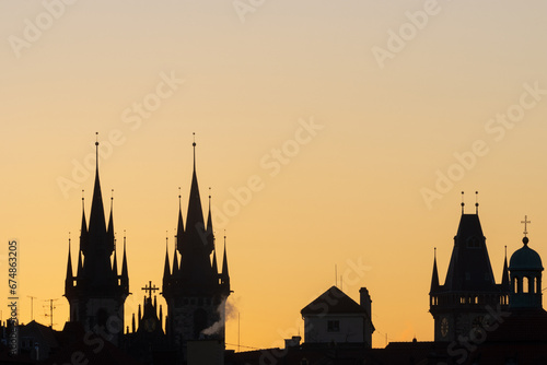 Silhouett of Prague's towers at sunrise.