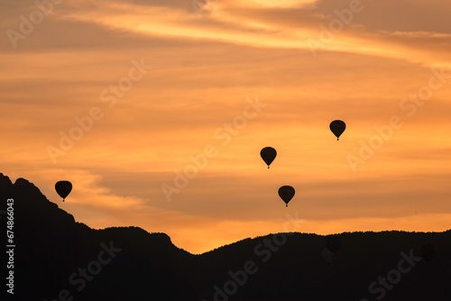 Hot Airl Balloons at Sunrise over Albuquerque and Sandia Mountains, New Mexico photo