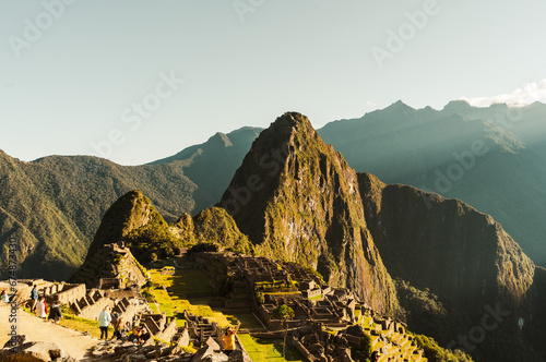 world heritage site Machu Picchu in Peru at sunrise with sunrays on the mountain