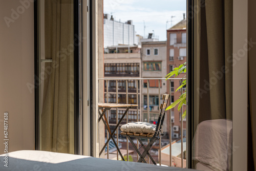 Photography Small table and chair on sunny terrace view from apartment
