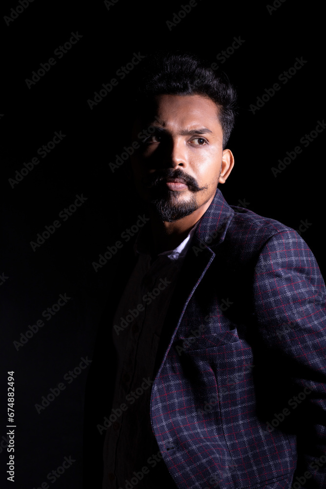Fototapeta premium portrait of a man with moustache's wearing coat